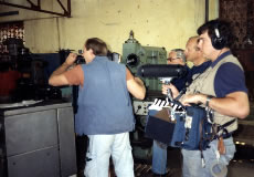 Crew filming empty factories.